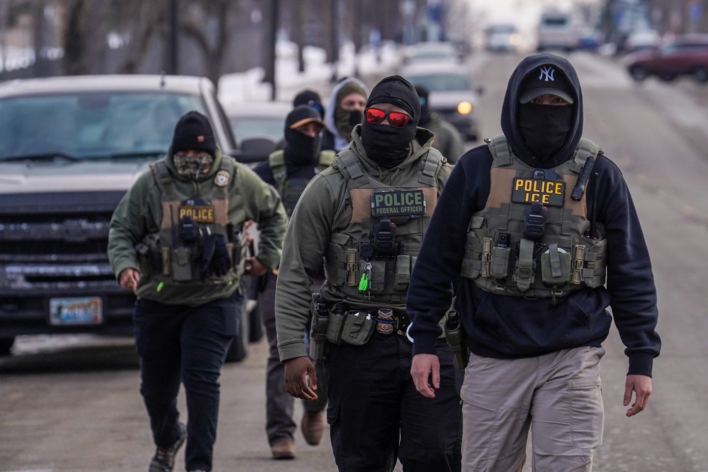 FILE - Federal agents walk down a street while conducting immigration enforcement operations, Thursday, Feb. 5, 2026, in Minneapolis. (AP Photo/Ryan Murphy, File)
