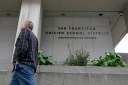 A man walks by the San Francisco Unified School District administrative building.