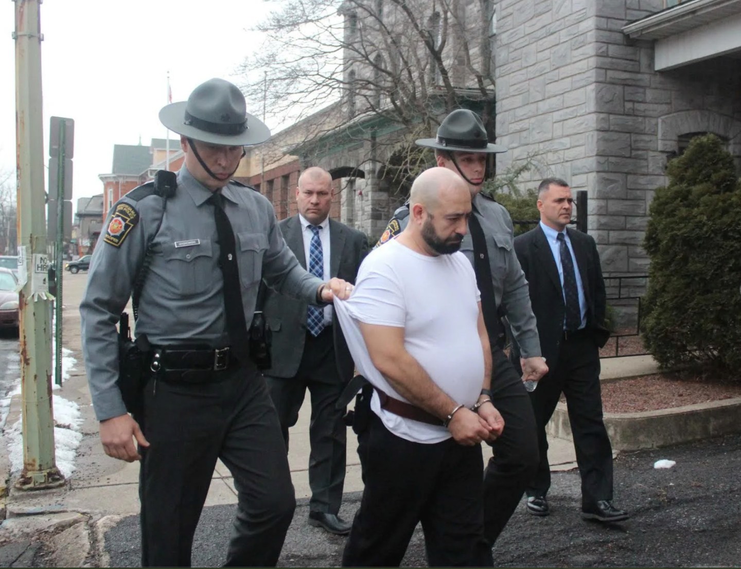 John Edward Kurtz, a former prison guard, is taken by state troopers to be arraigned in Milton, Pa., Dec. 18, 2017.