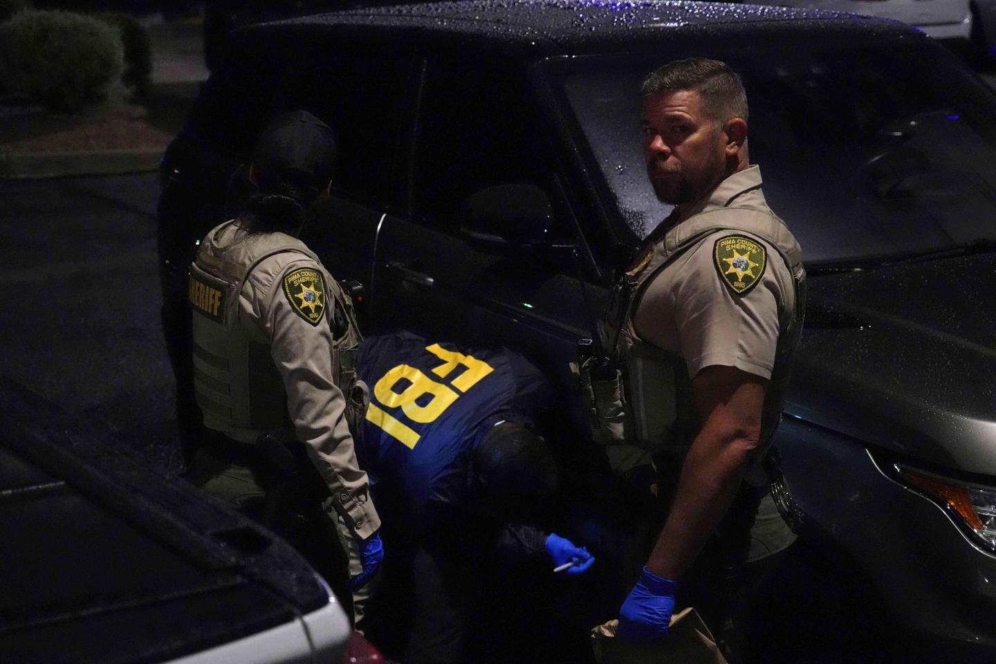 Pima County sheriff and FBI work on a Range Rover in a Culver’s parking lot in Tucson, Ariz. early Saturday, Feb. 14, 2026.