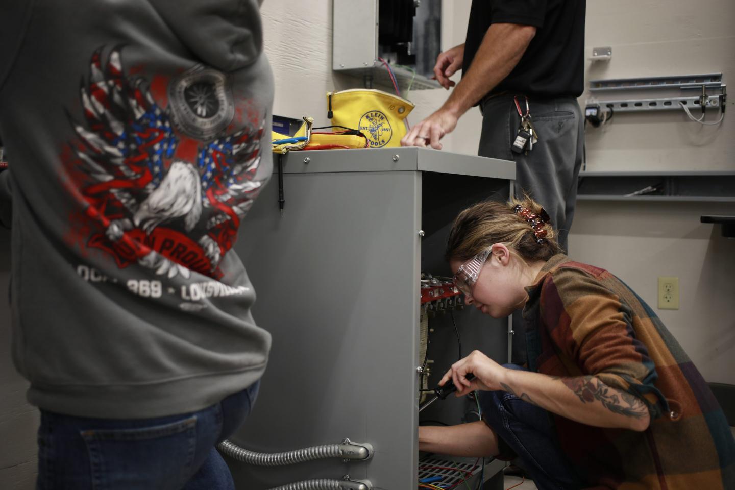 Electrician apprentices at work.
