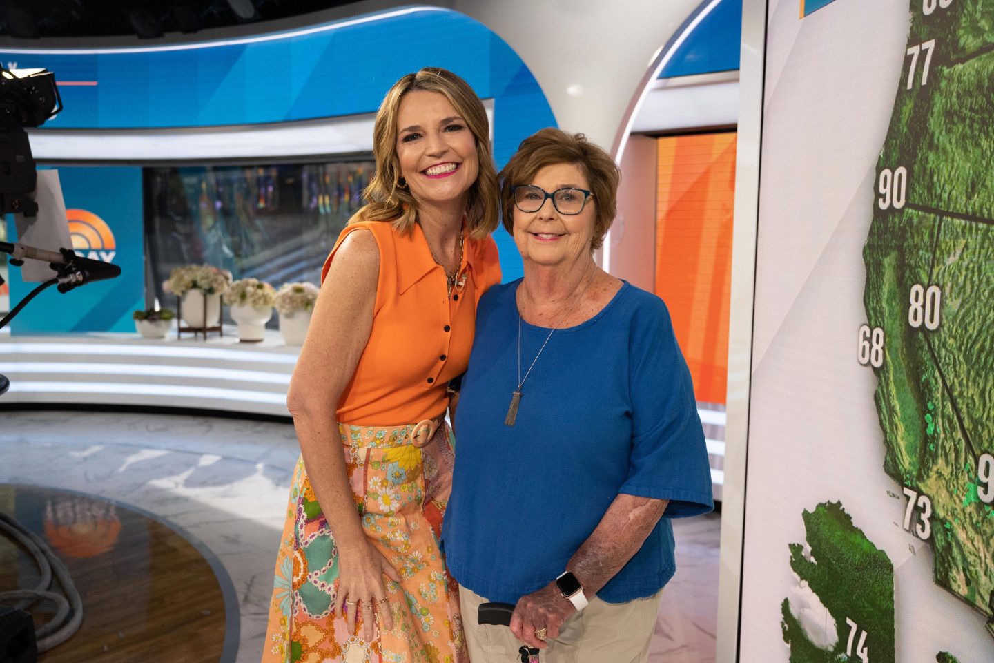 A mother and daughter smile in a TV studio