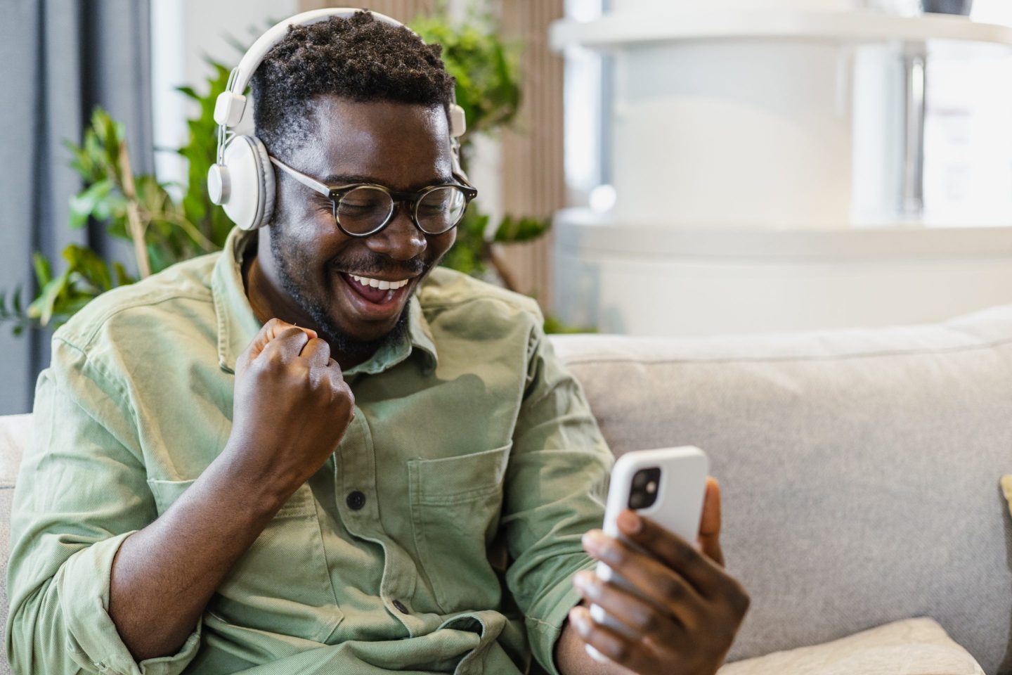 Young man smiling as he looks at his phone