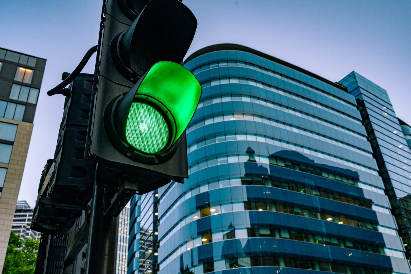 A green traffic light on the street at dawn