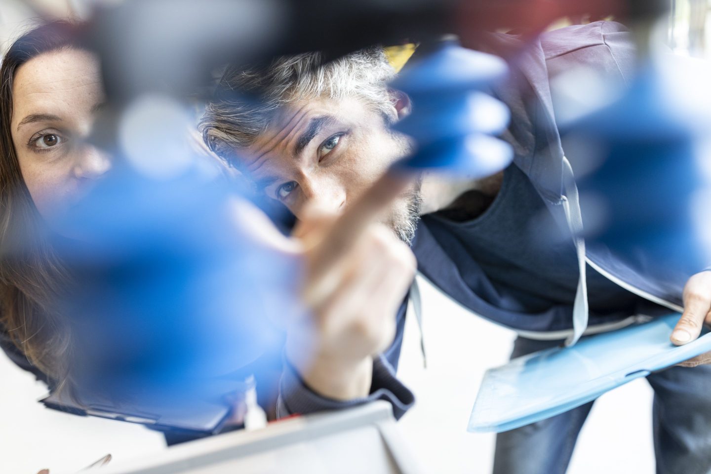 Photo of technicians looking at an industrial robot
