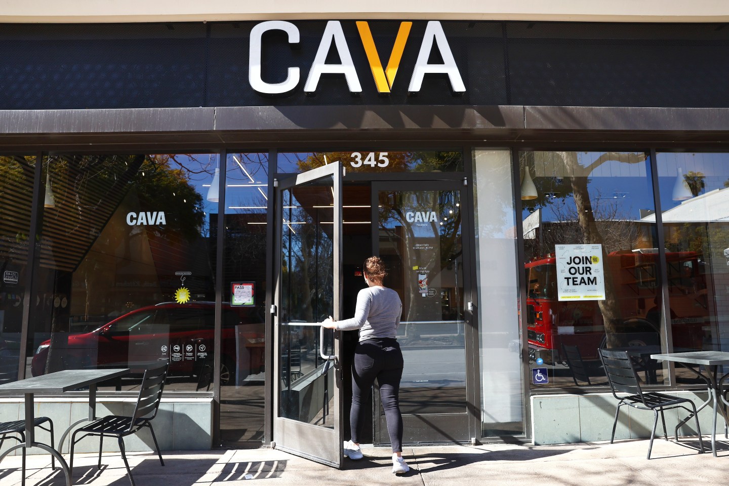 A customer enters a Cava restaurant chain location.