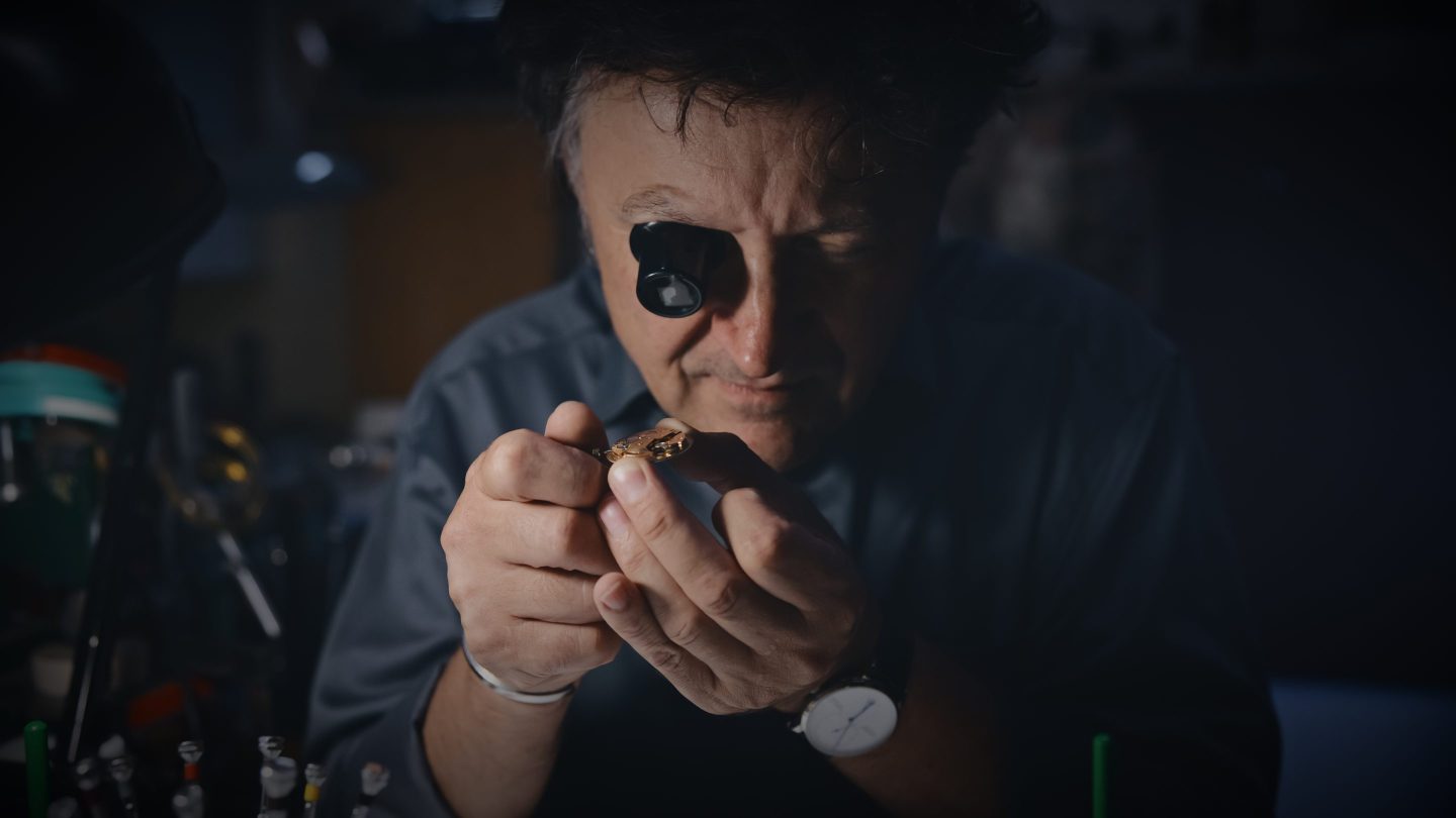 Watchmaker repairing a watch