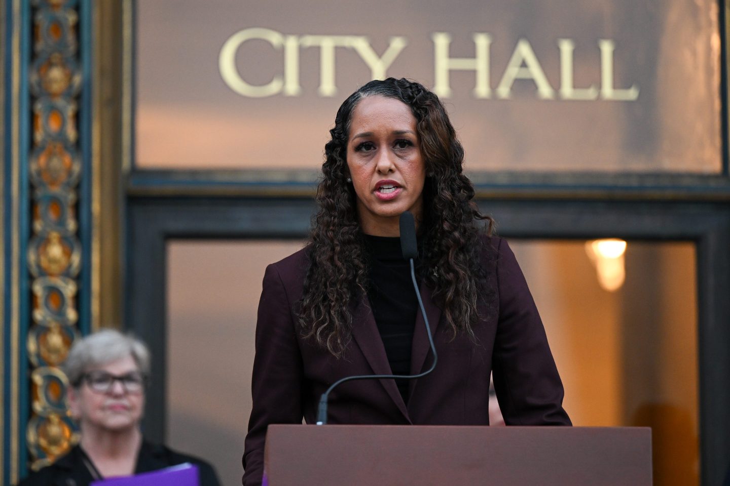 Jenkins stands a podium in front of San Francisco City Hall