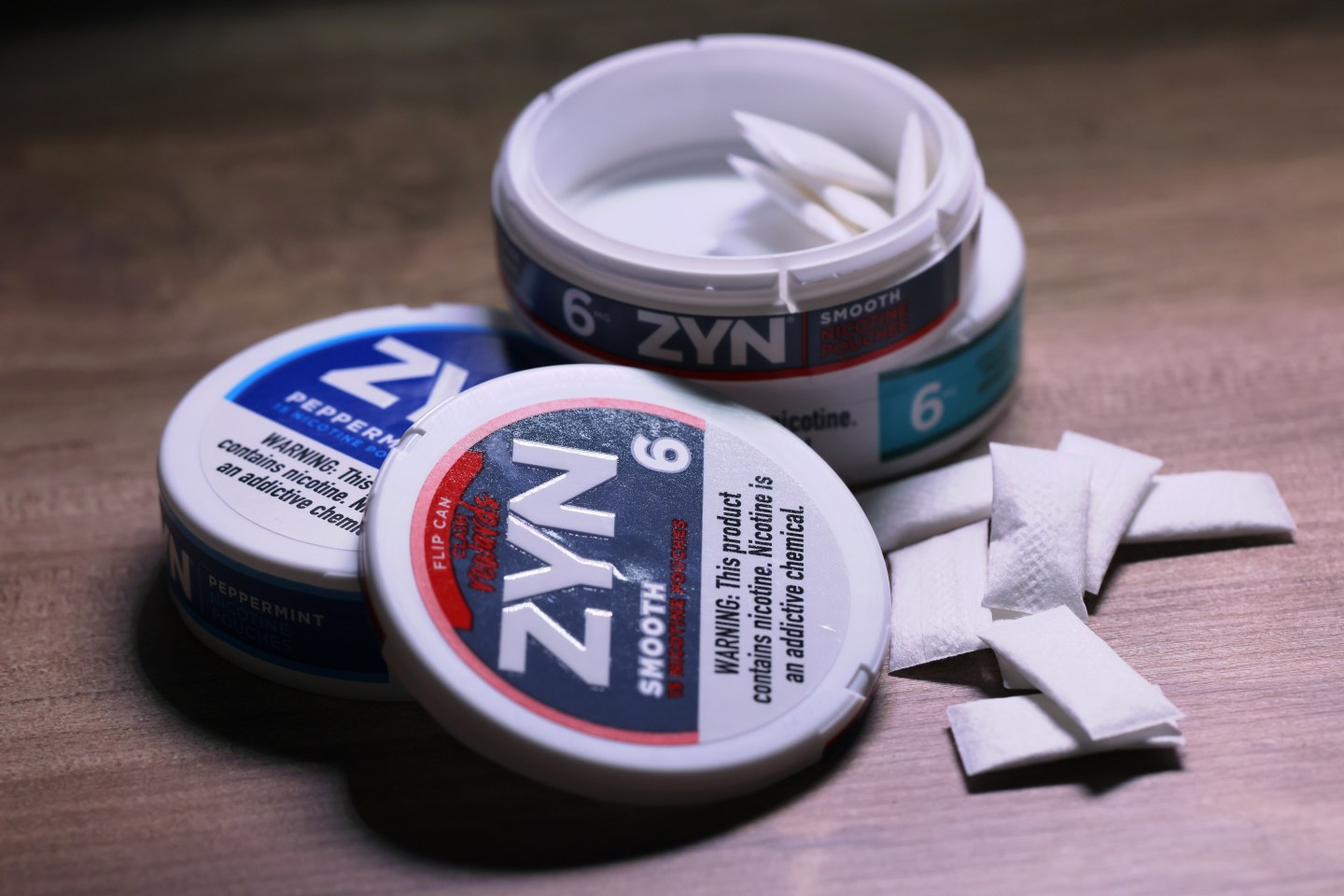 an open case of Zyn nicotine pouches on a table.
