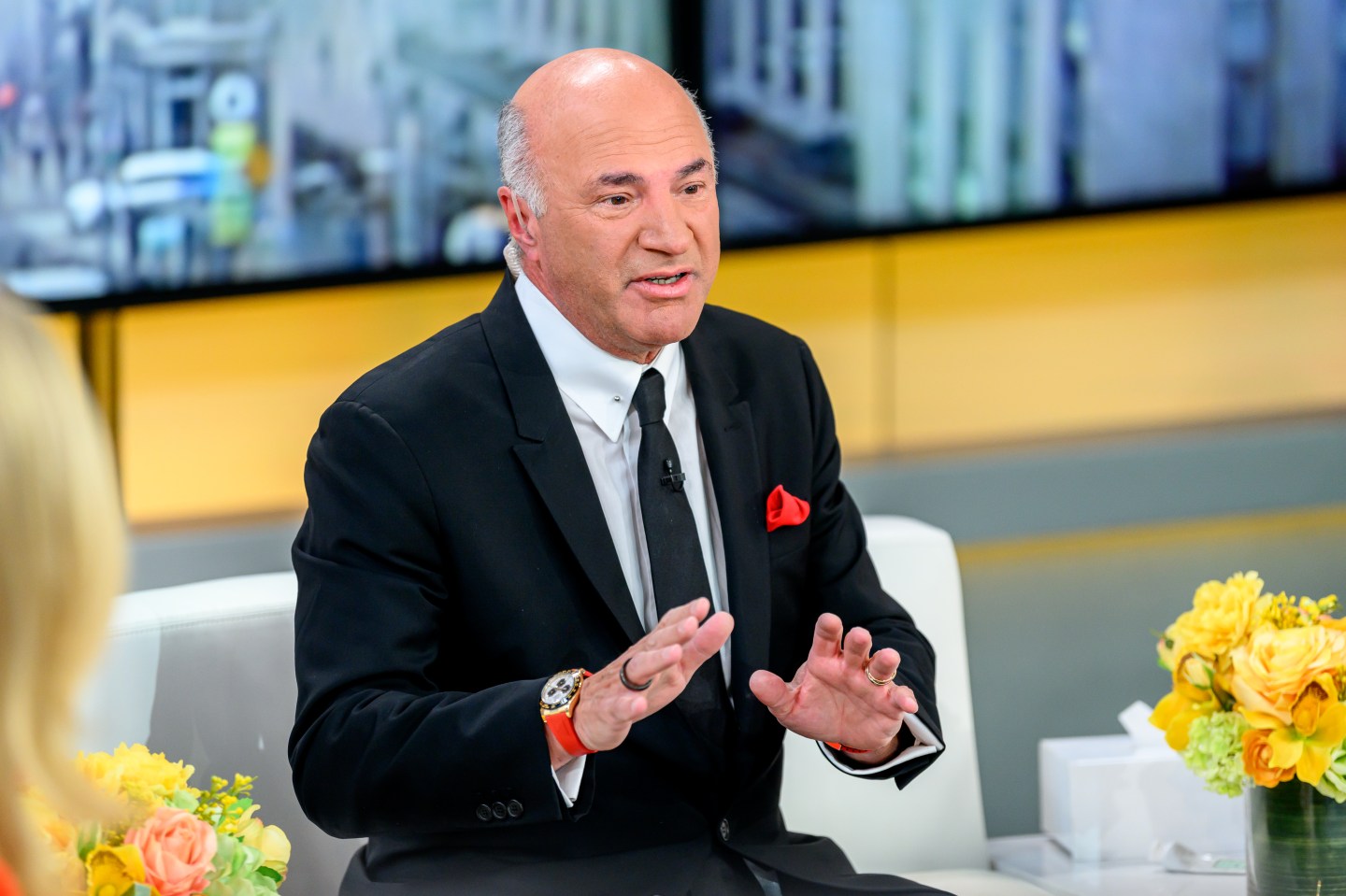 Kevin O'Leary wears a suit and gestures