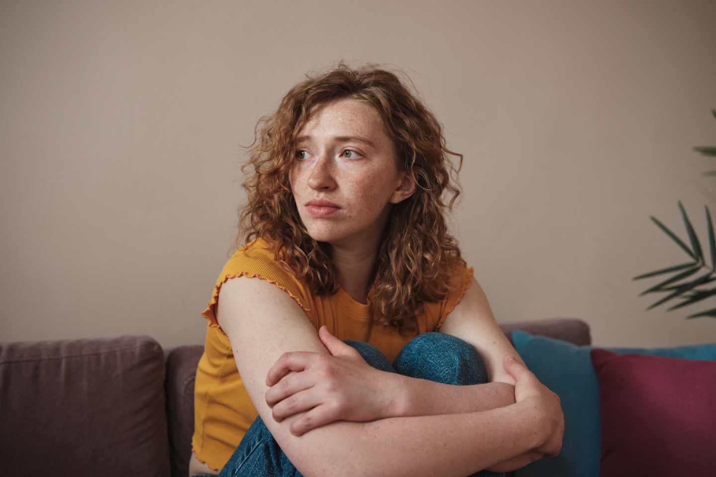 A woman sits and contemplates.