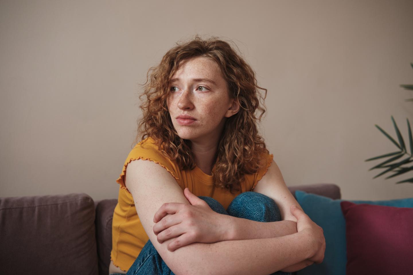 A woman sits and contemplates.