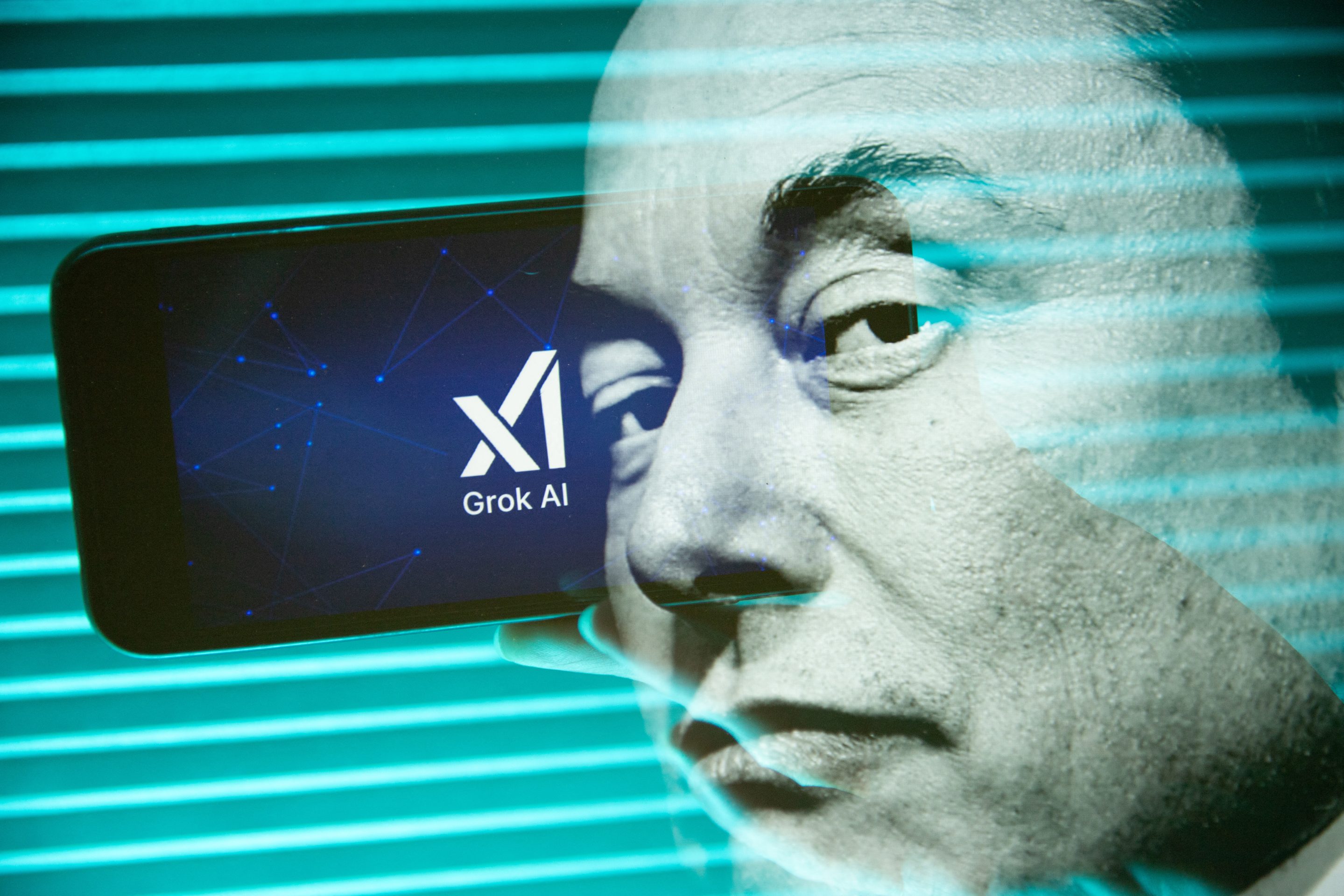 Elon Musk in front of the xAI logo.
