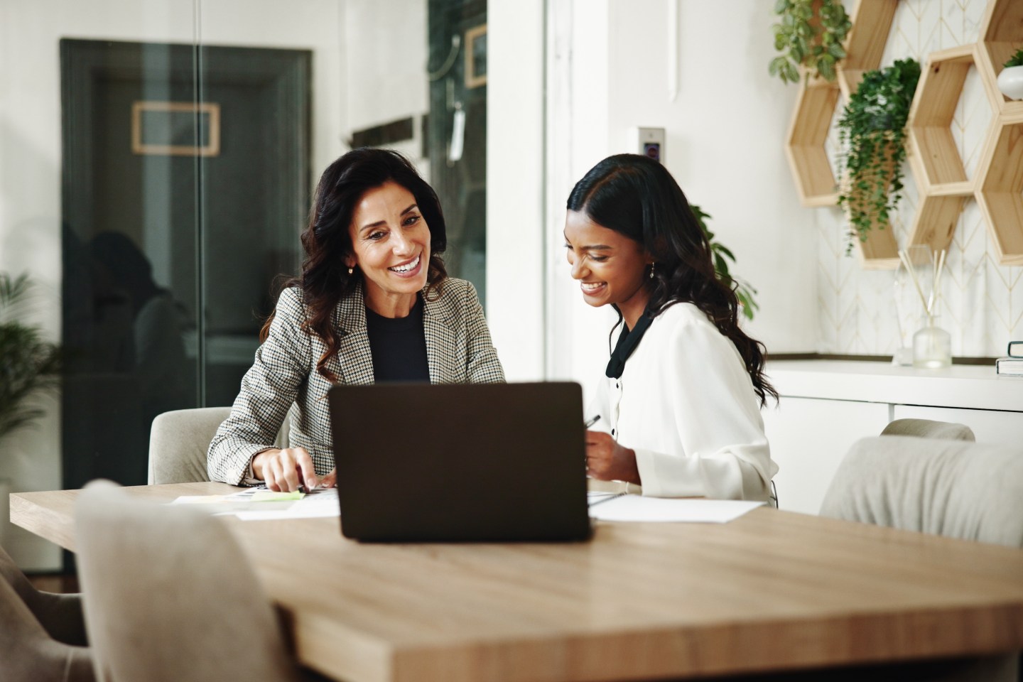 Meeting, women and business people with laptop in office, investment project and discussion. Teamwork, accountant and financial advisor with feedback for finance update, report review and documents