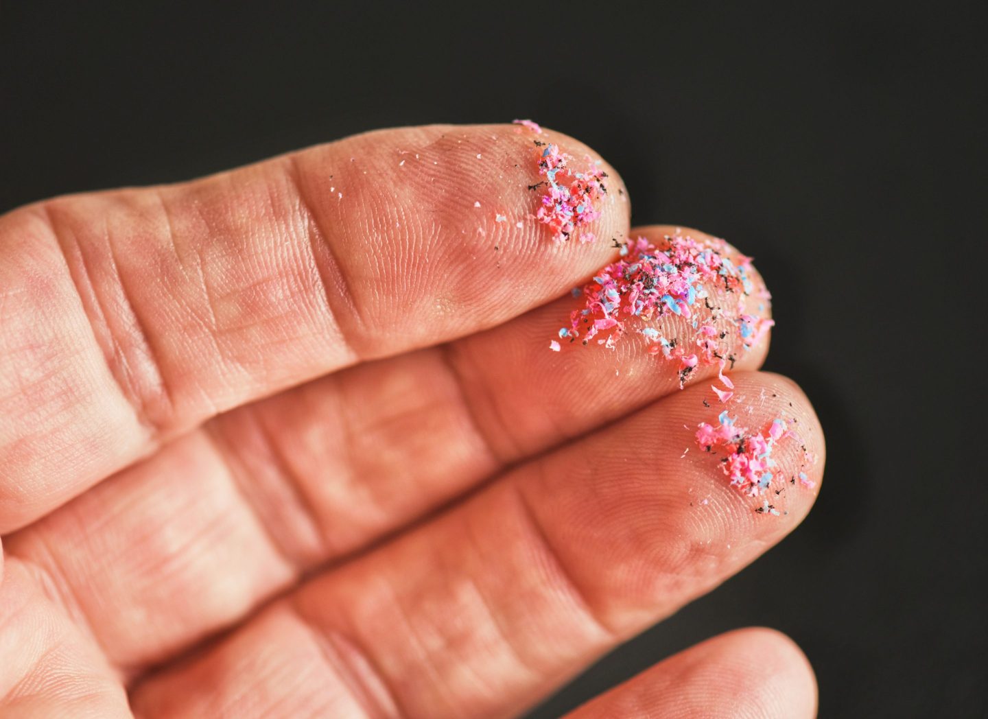 Photo of fragments of plastic on fingers