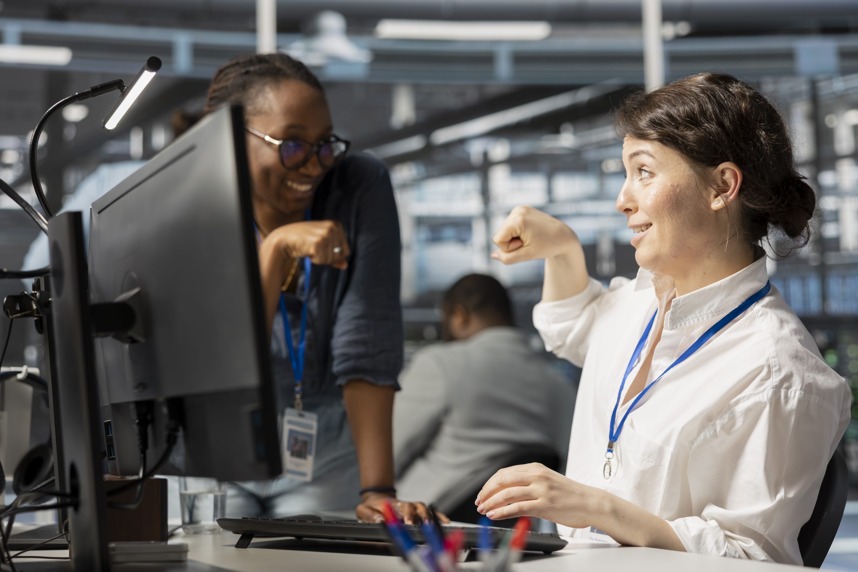 Happy tech workers fist bump