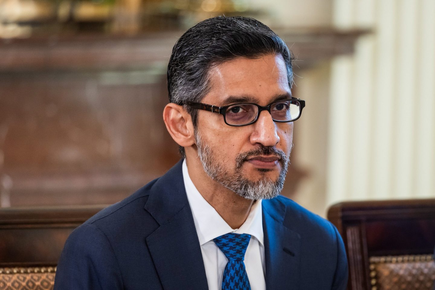 A man in a suit wearing glasses.