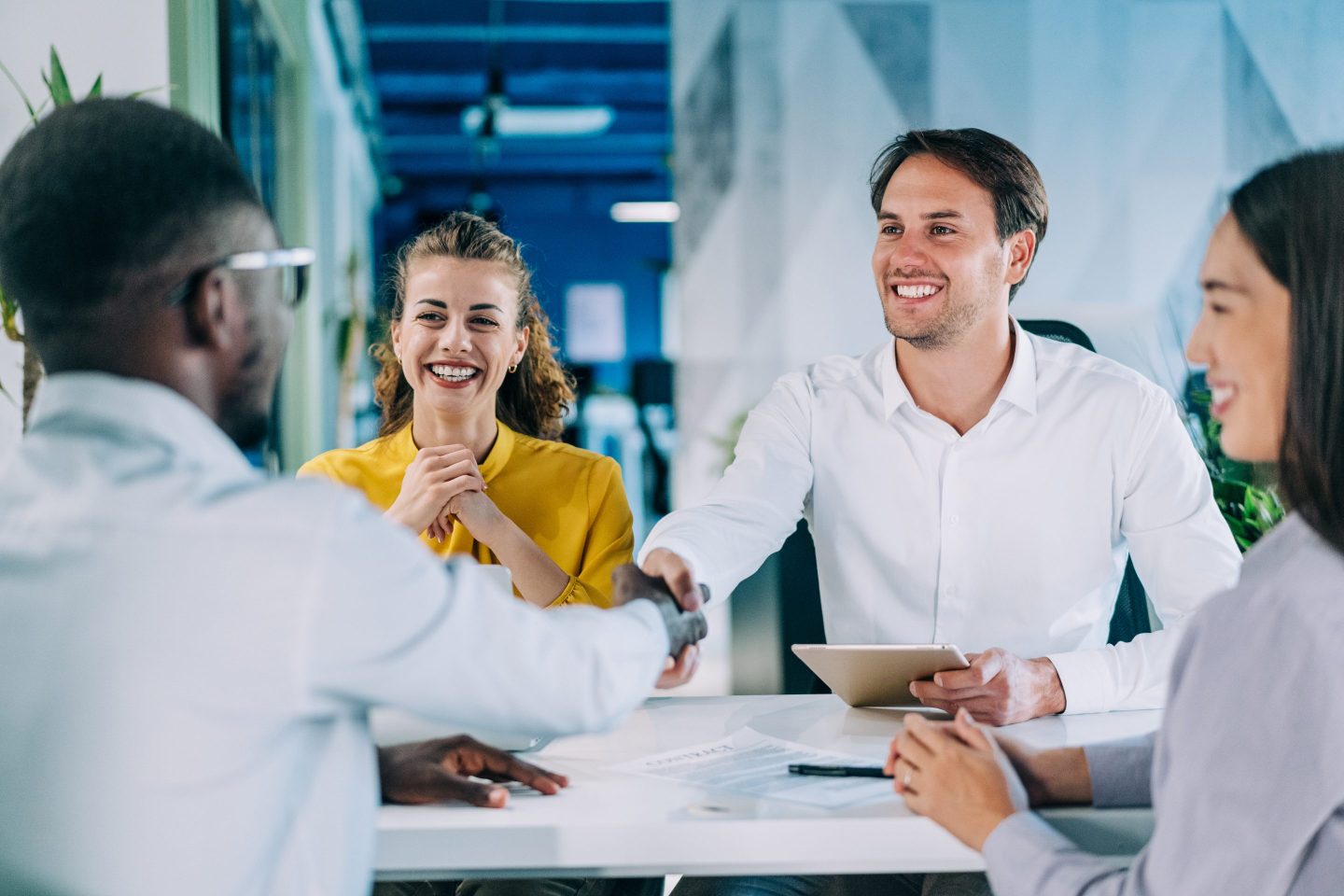 Businessmen shaking hands across the table