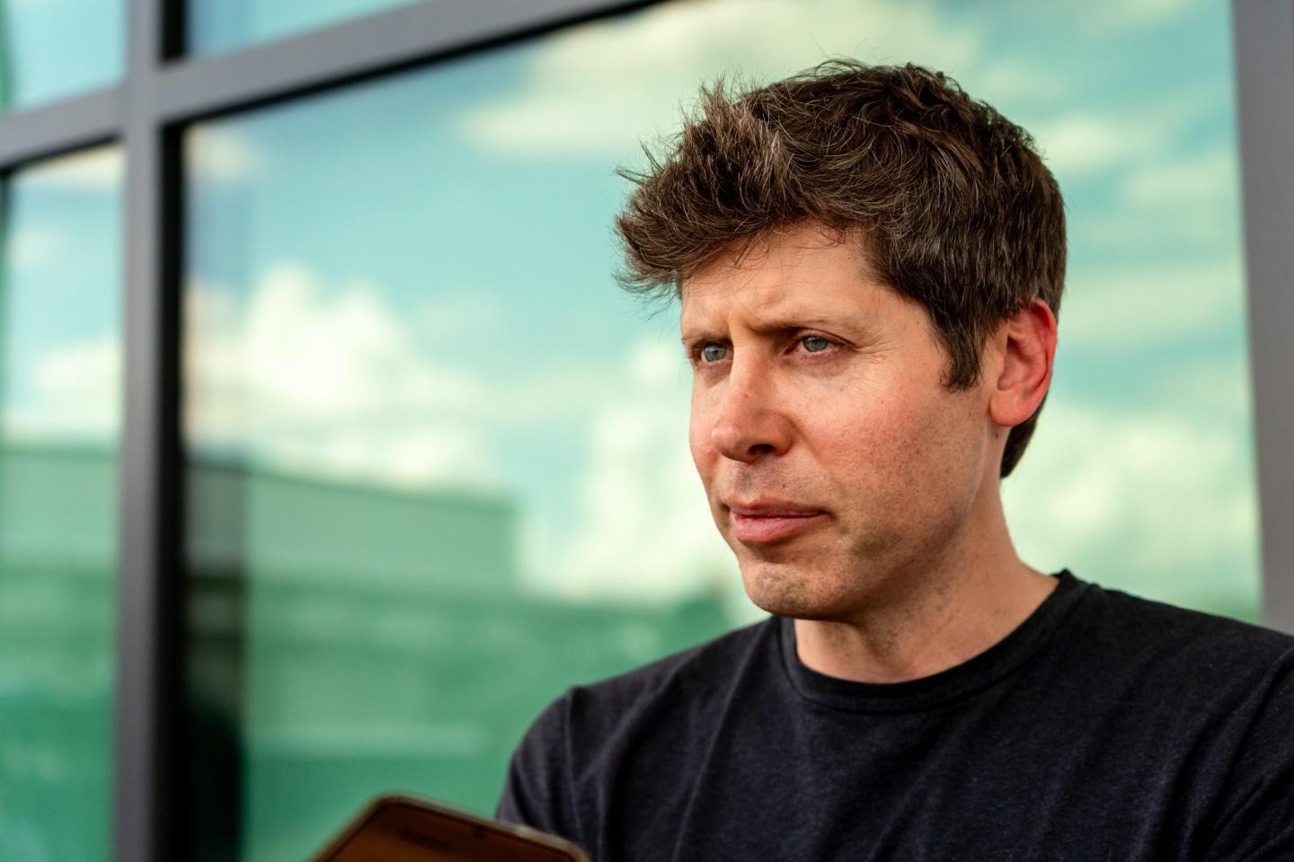 OpenAI Sam Altman looking into the distance.
