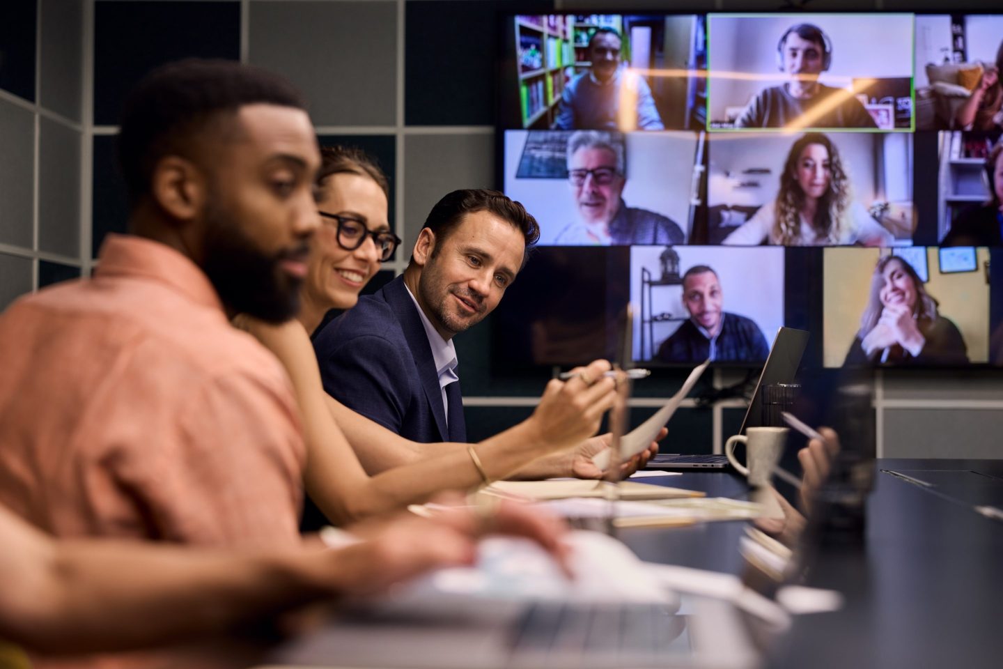 A hybrid meeting between both virtual and in person employees.