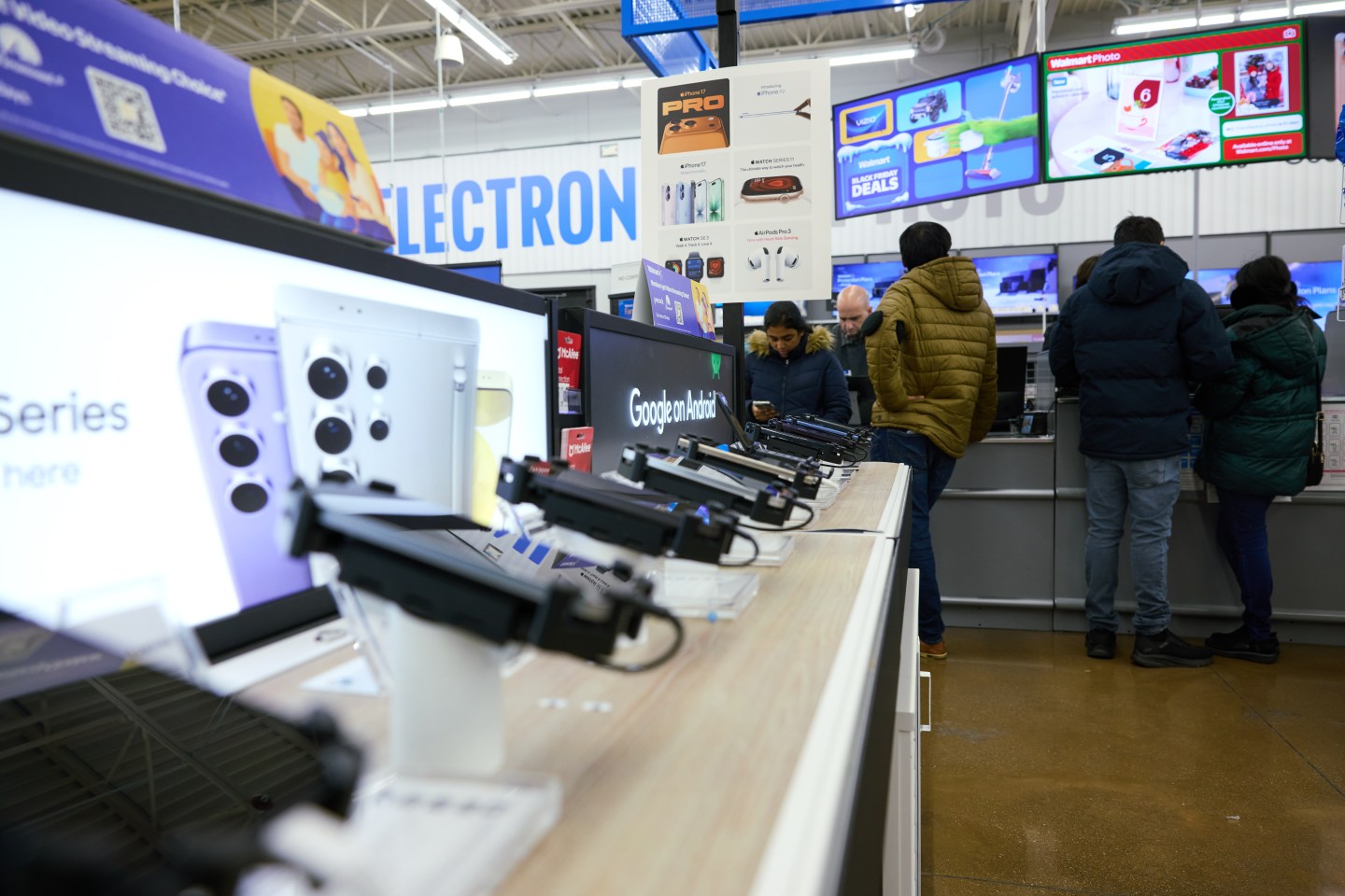 Customers in the electronics section at Walmart on Black Friday in Columbus, Ohio, US, on Friday, Nov. 28, 2025. Americans are planning to spend more this holiday season than last year, according to credit reporting firm TransUnion. Photographer: Brian Kaiser/Bloomberg via Getty Images