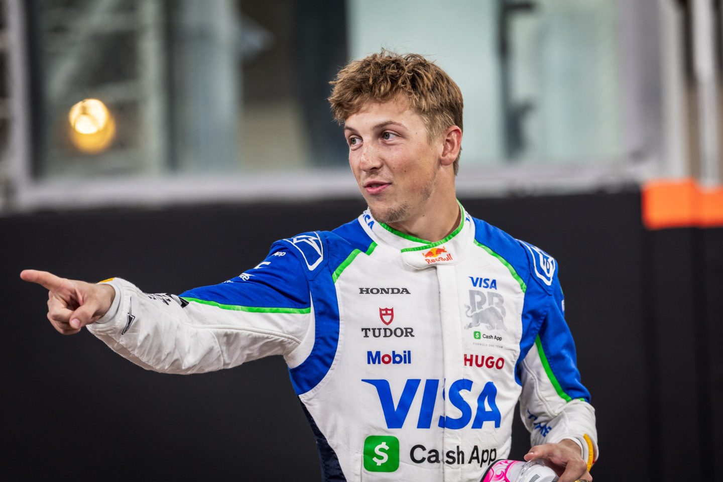 Liam Lawson points in his Visa uniform.