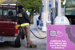 A driver refuels a vehicle at a Chevron gas station in San Mateo, California, US, on Thursday, Jan. 29, 2026. Chevron Corp. is expected to release earnings figures on January 30. Photographer: Benjamin Fanjoy/Bloomberg via Getty Images