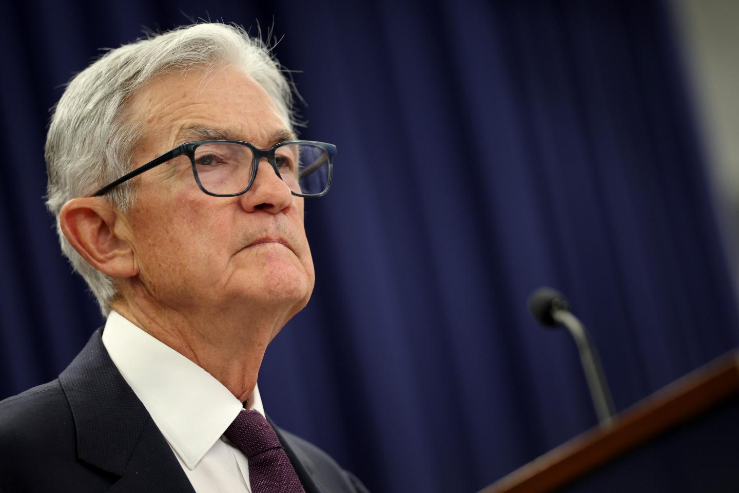 Jerome Powell, standing behind the podium, looking out in front of him.
