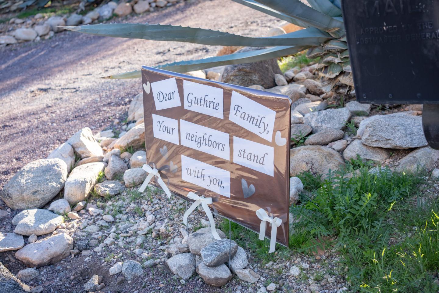 A sign outside of a home with Guthrie’s name on it