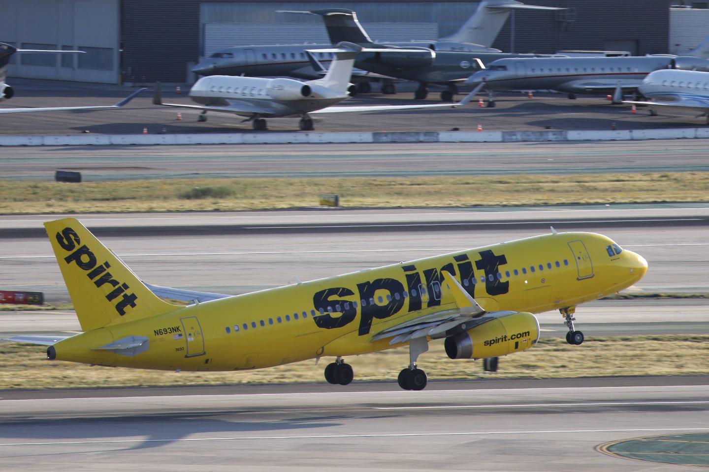 A spirit airlines plane on a tarmac.