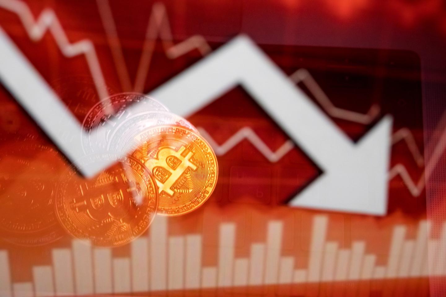 arrow pointing down next to Bitcoin logo