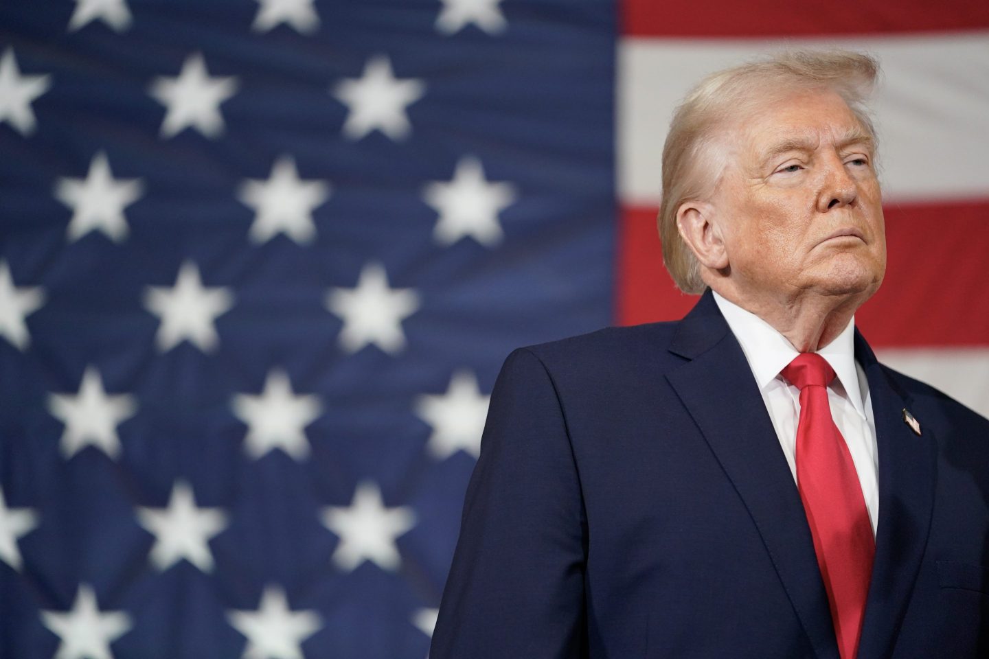 President Donald Trump pictured in North Carolina standing in front of an American flag