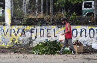 A man walks past graffiti of the late Cuban leader Fidel Castro on a street in Havana on Feb. 16, 2026.