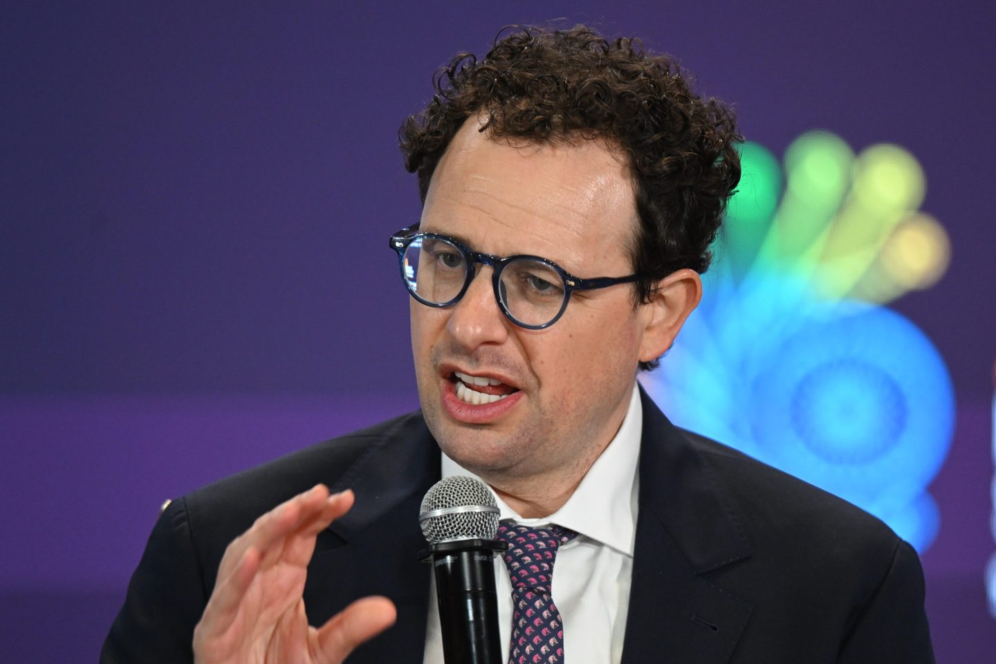 Anthropic CEO Dario Amodei speaking in front of a microphone.