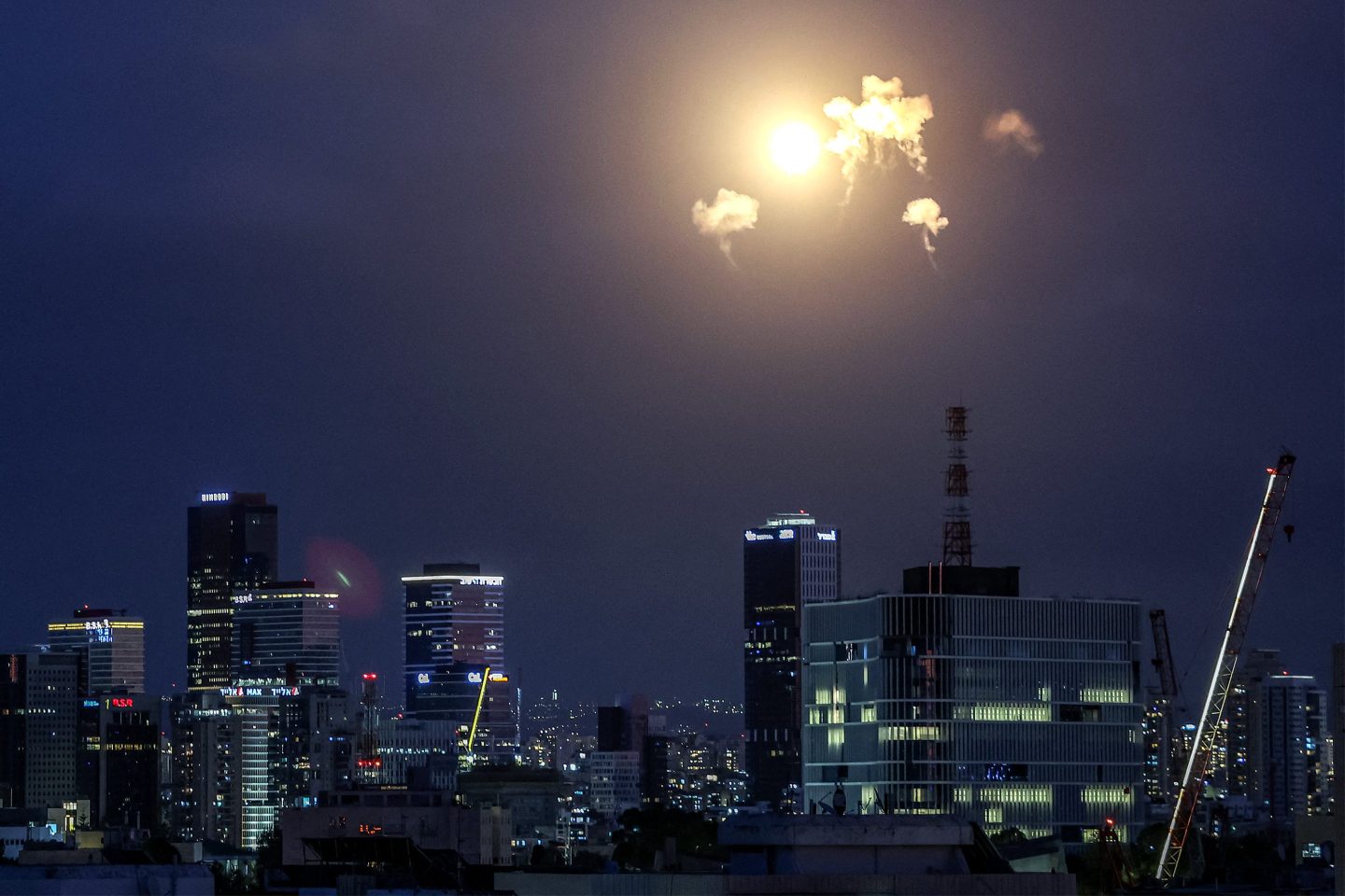 Explosions from projectile interceptions by Israel's Iron Dome missile defence system are pictured over Tel Aviv on February 28, 2026. The United States and Israel launched strikes against Iran on February 28, with Israel's public broadcaster reporting that the Iranian supreme leader had been targeted, as the Islamic republic retaliated with barrages of missiles at Gulf states and Israel. (Photo by Jack GUEZ / AFP via Getty Images)