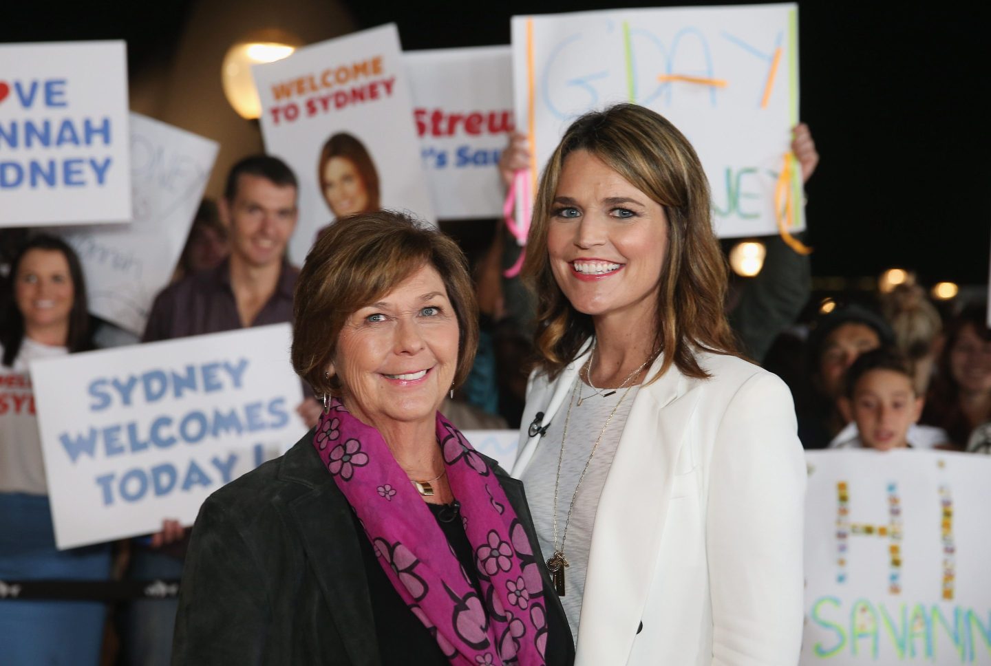 two women pose in front of camera