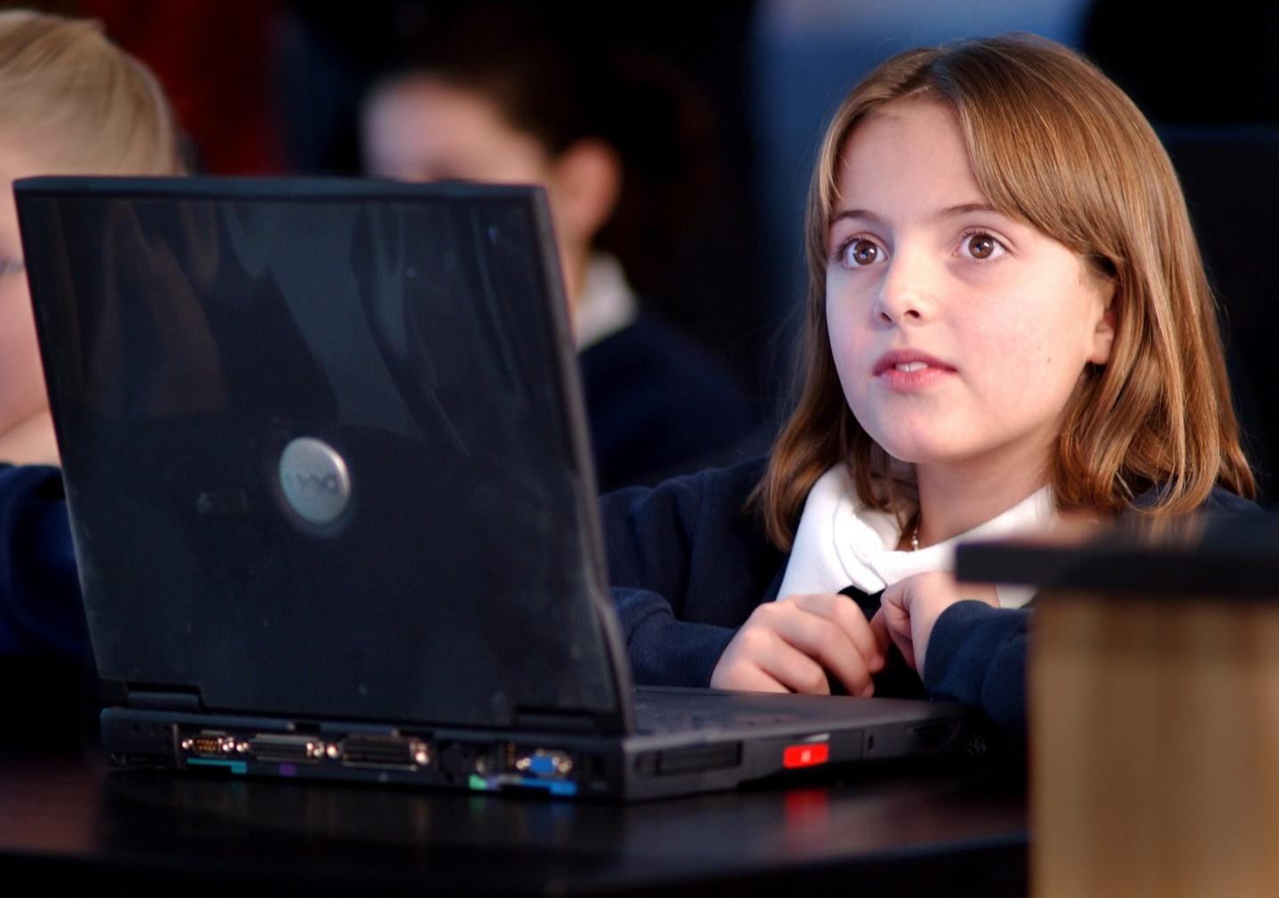 A girl looking at her laptop screen
