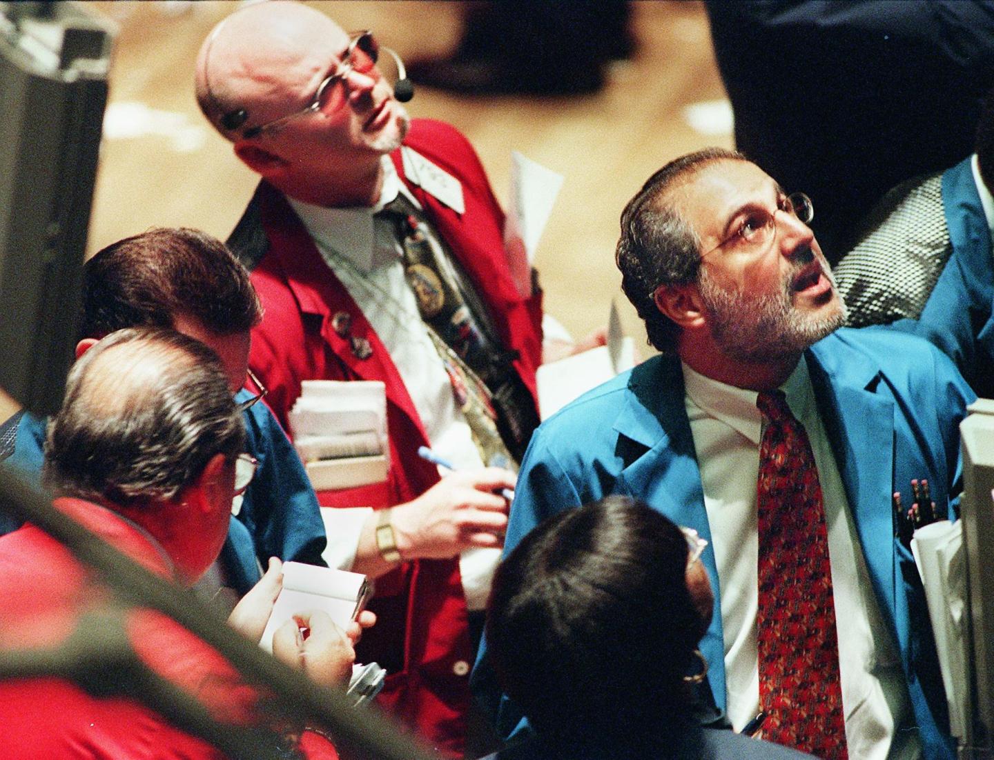 Traders on the floor of the New York Stock Exchange monitor the early moves of the market soon after the trading day began in New York 05 August, 1999.