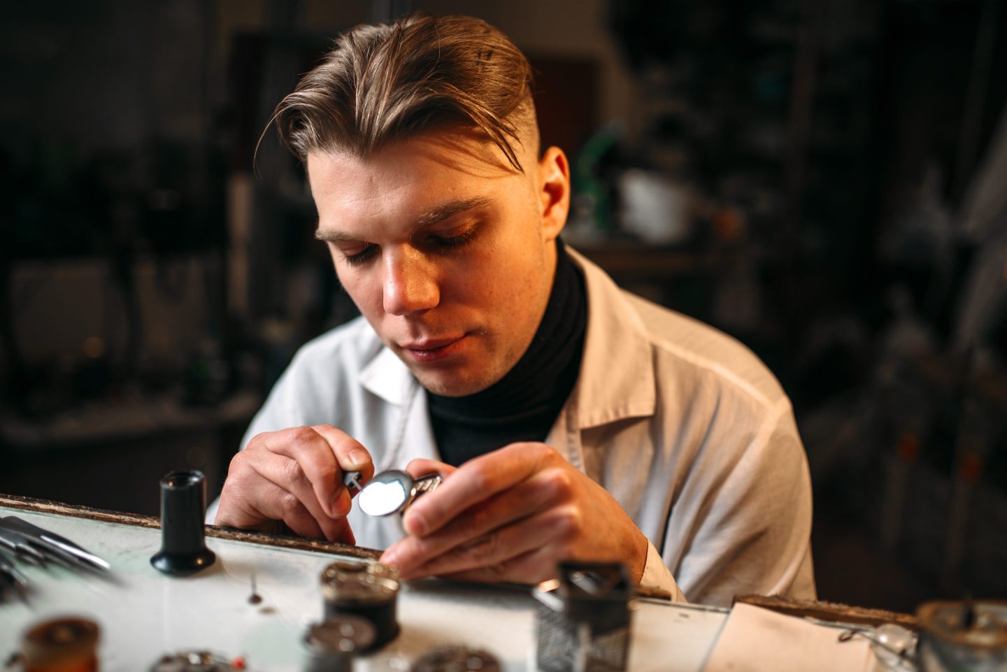 Watchmaker repairs broken watch