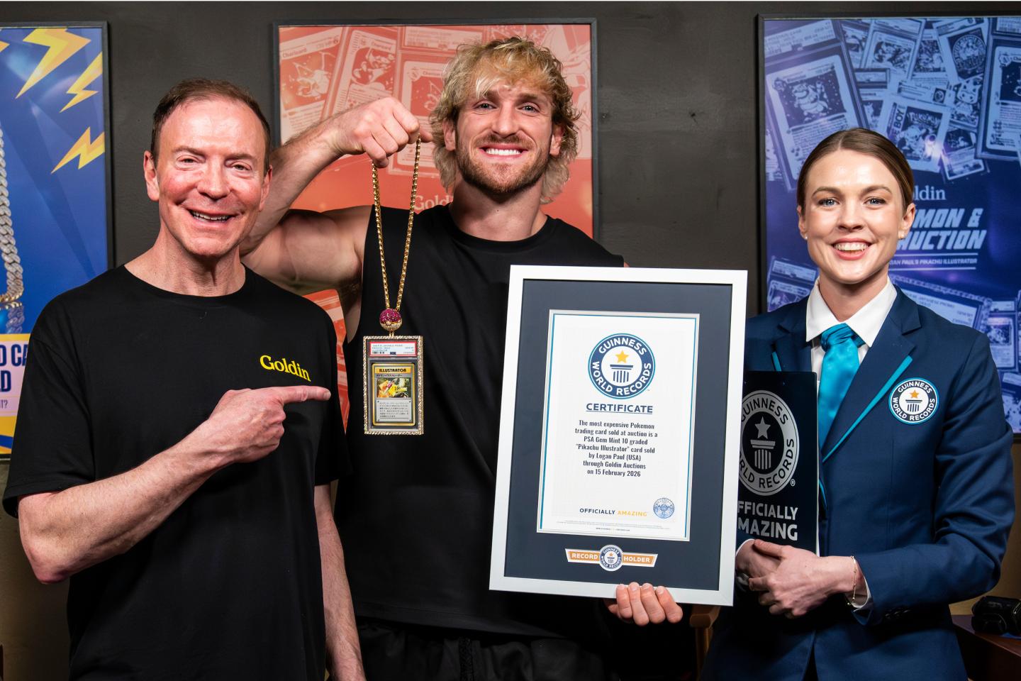 Ken Goldin, Logan Paul, and a Guinness World Record woman stand with Paul's Pokemon card
