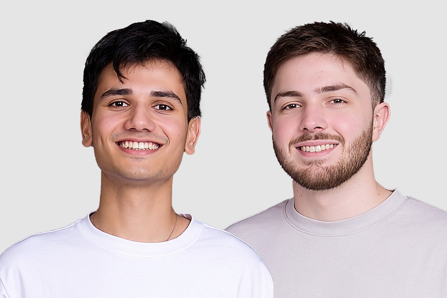 two men smile in front of the camera