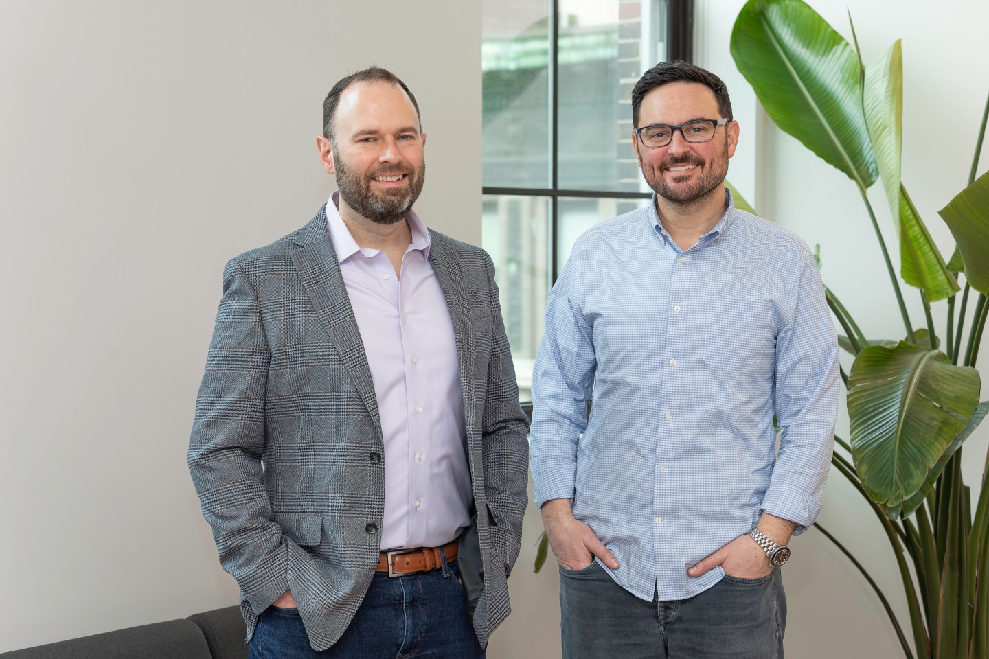 two men pose for photo