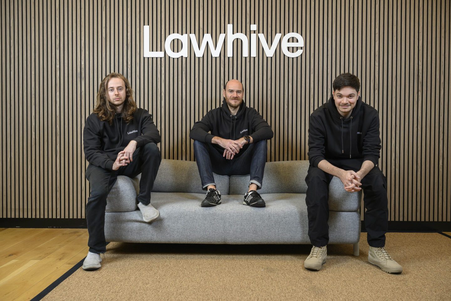 Lawhive's cofounders seated on a sofa.
