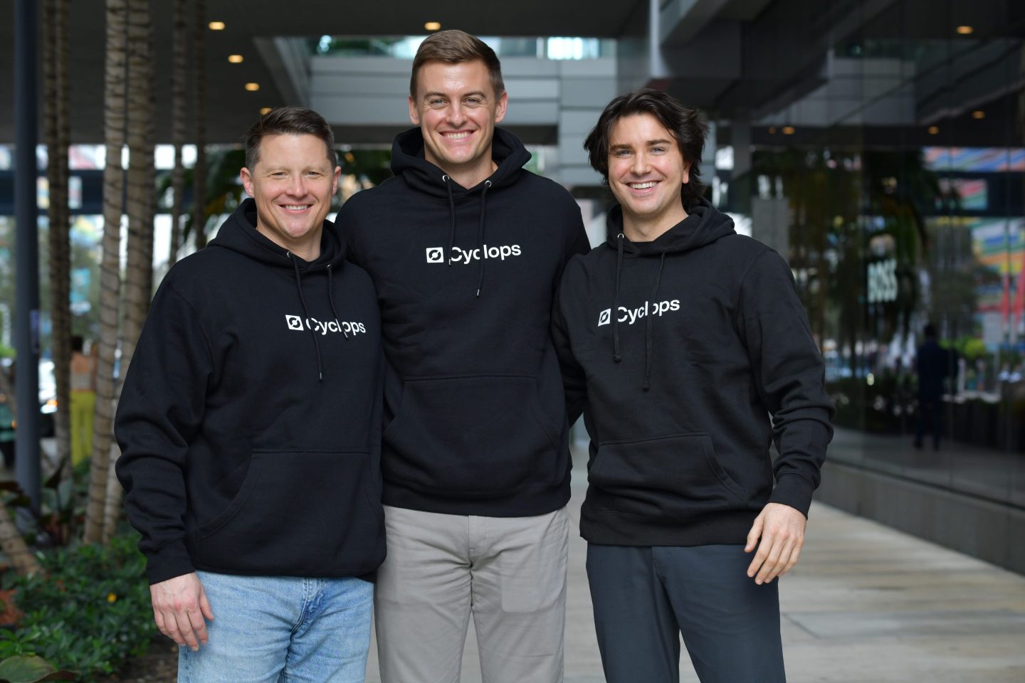 three men pose for photo