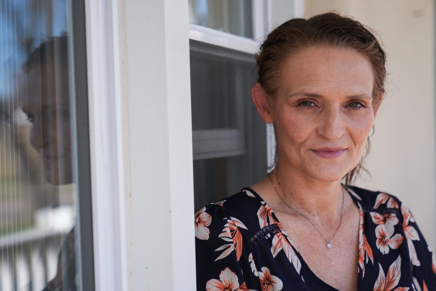 Jessica Thompson poses outside her home.