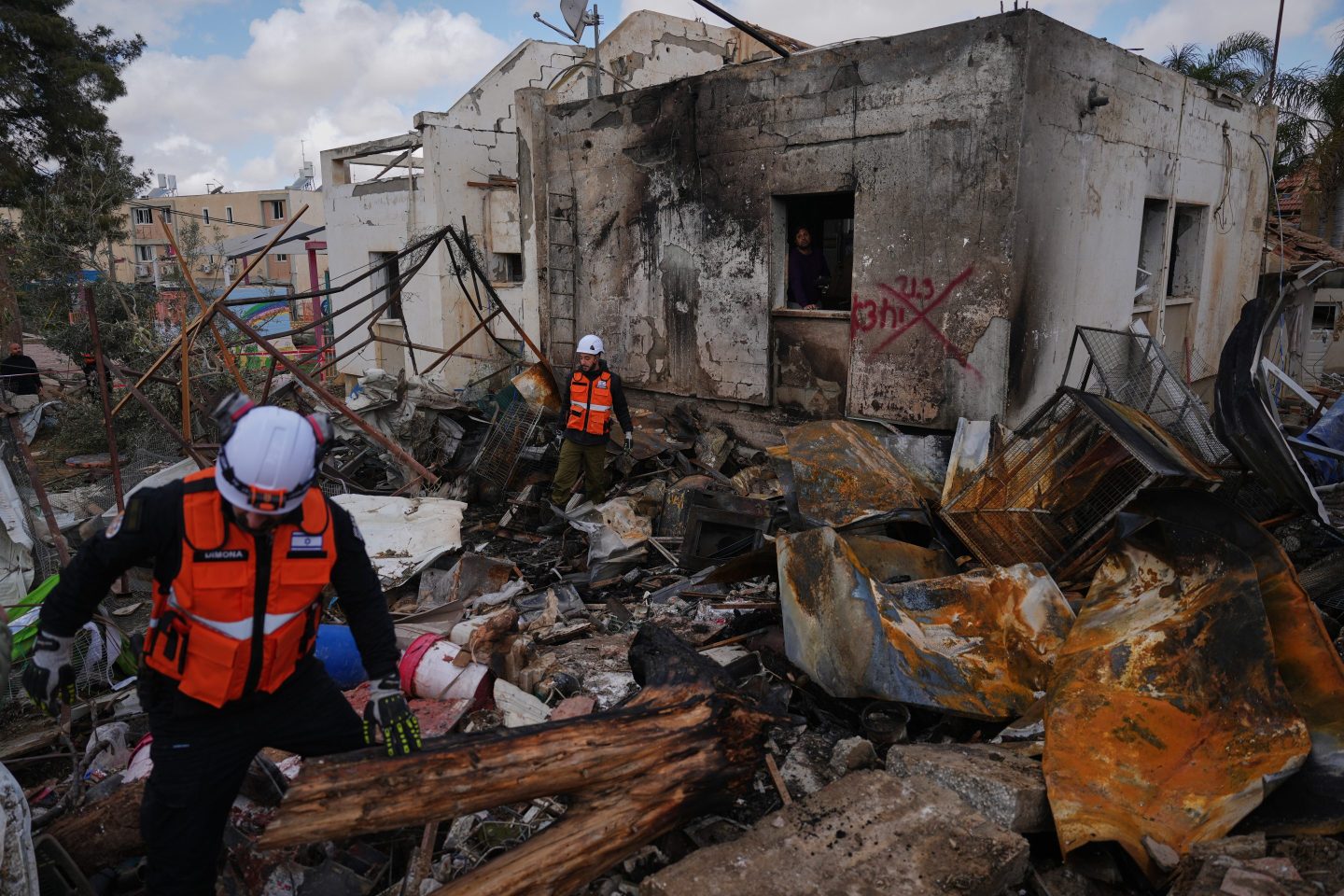 Israeli security forces survey the site that was struck by an Iranian missile in Dimona, southern Israel, Sunday, March 22, 2026. (AP Photo/Ariel Schalit)