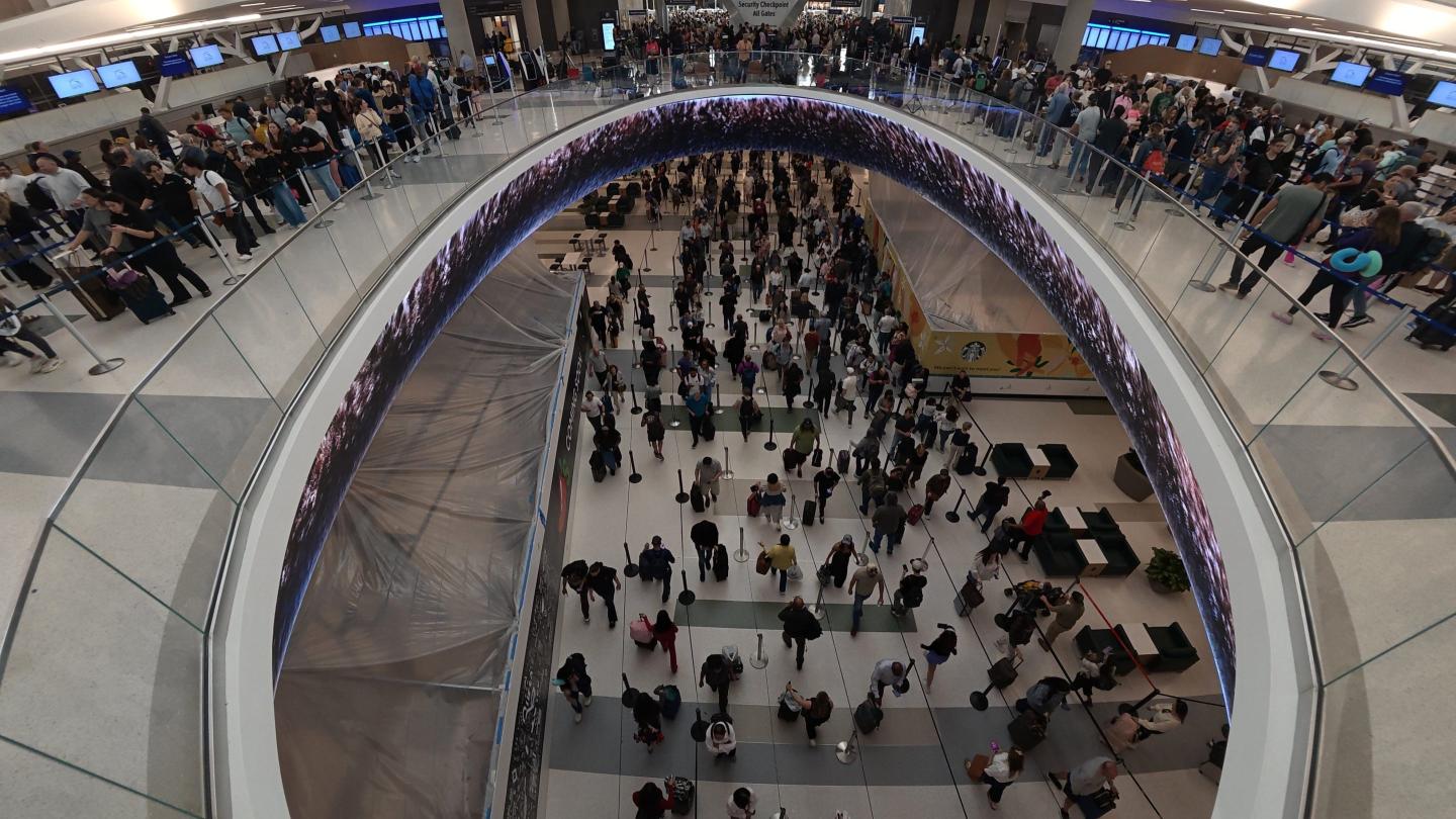 Travelers line up at a TSA checkpoint at George Bush Intercontinental Airport in Houston, Thursday, March 26, 2026. 