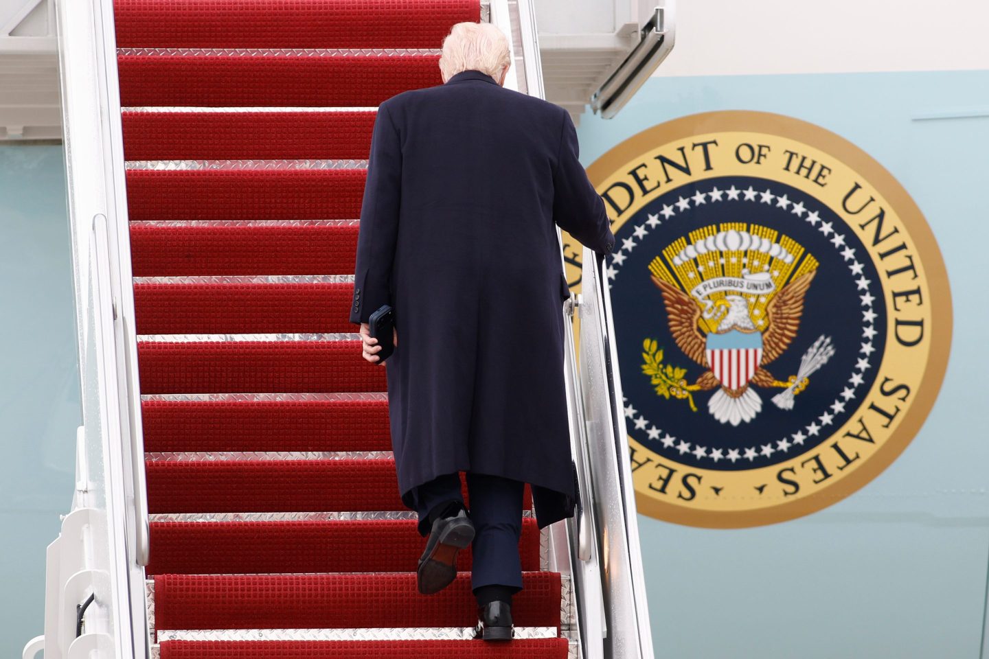 President Donald Trump walks up the stairs of Air Force One at Joint Base Andrews, Md., Friday, March 27, 2026. (AP Photo/Luis M. Alvarez)