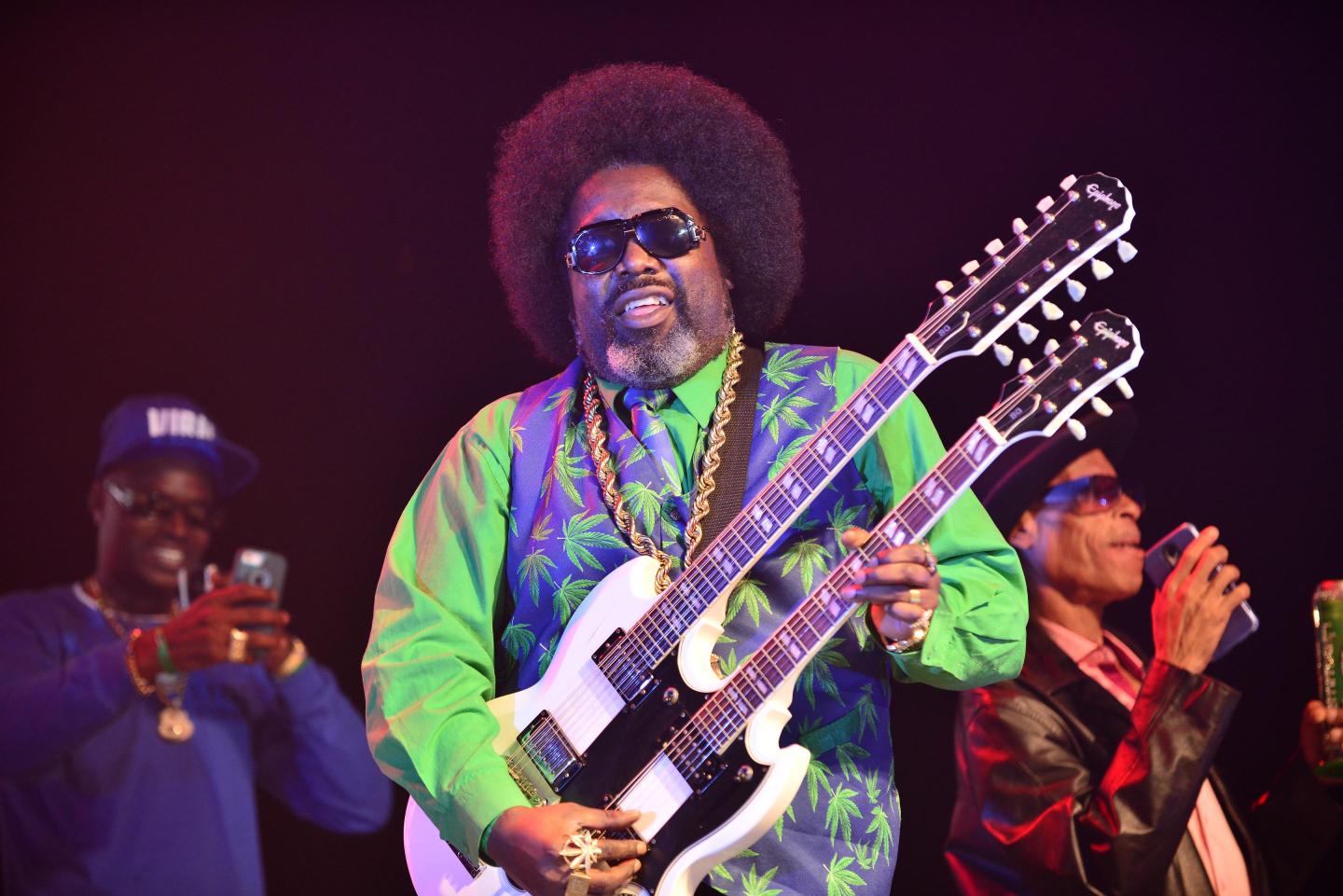 man plays bass on stage