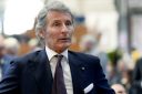 Stephan Winkelmann looks forward. He is wearing a suit.